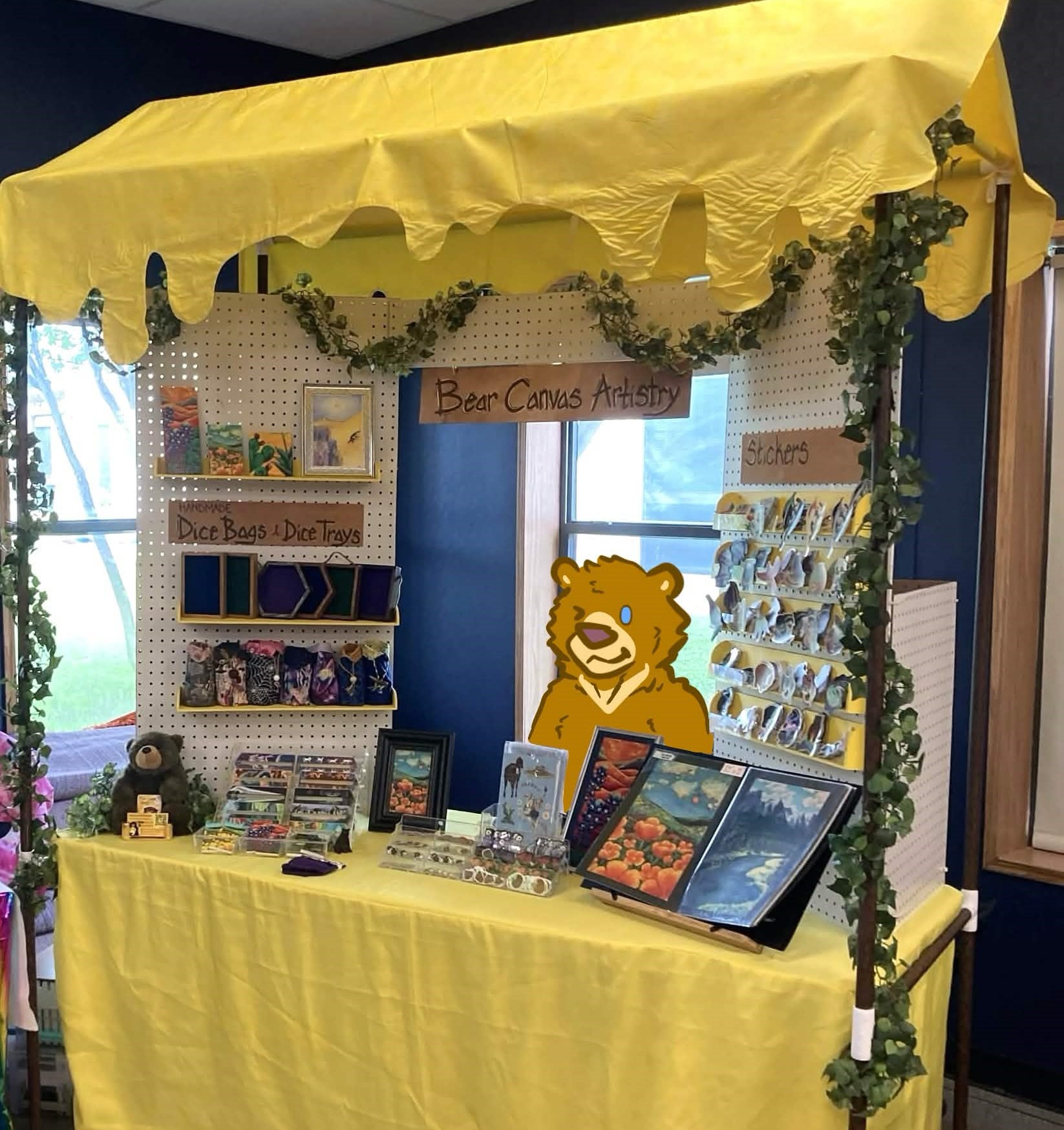 A picture of Bear Canvas Artistry's booth setup.